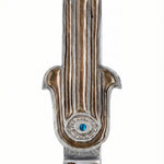 Amber Hamsa mezuzah case in hand-painted pewter enamel with earthy amber and rust tones. Made in Israel with a bold protective motif.
