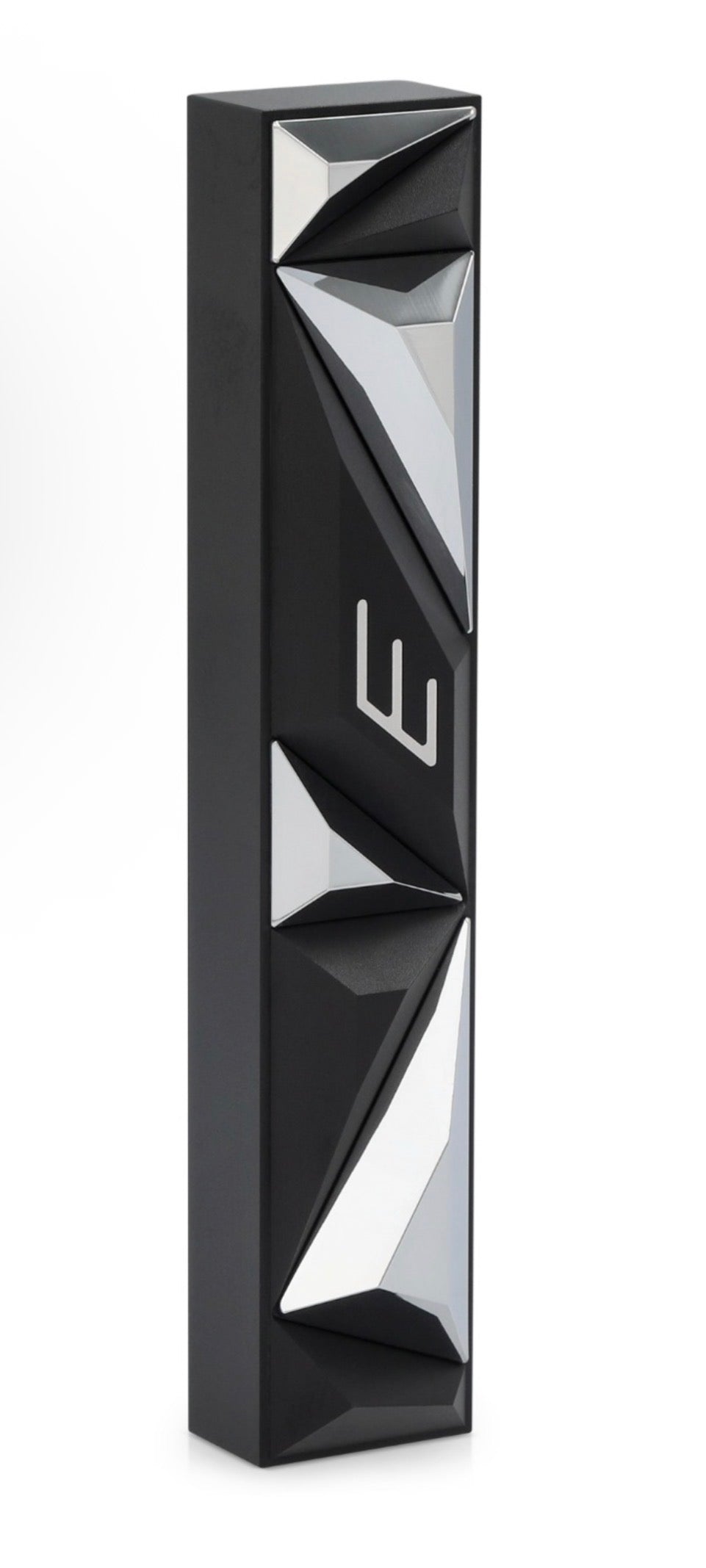 Black and silver geometric product on a white background