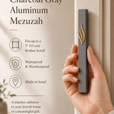 Modern charcoal gray and gold aluminum mezuzah with narrow rectangular architectural profile