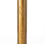 Gold glittery cylindrical object on a white background