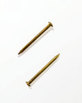 Gold mezuzah nails for mounting mezuzah cases to doorposts with a warm elegant hardware finish