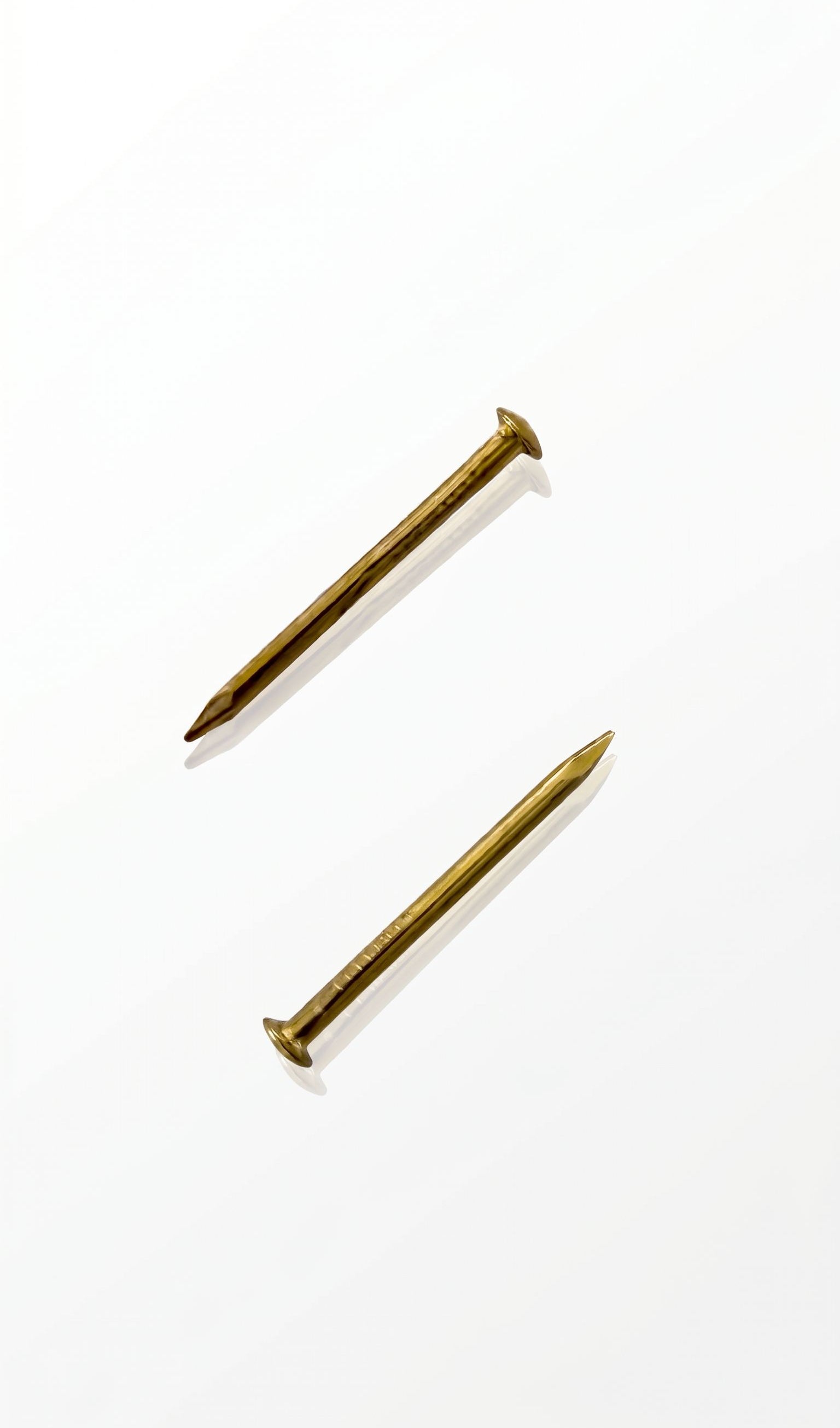 Gold mezuzah nails for mounting mezuzah cases to doorposts with a warm elegant hardware finish