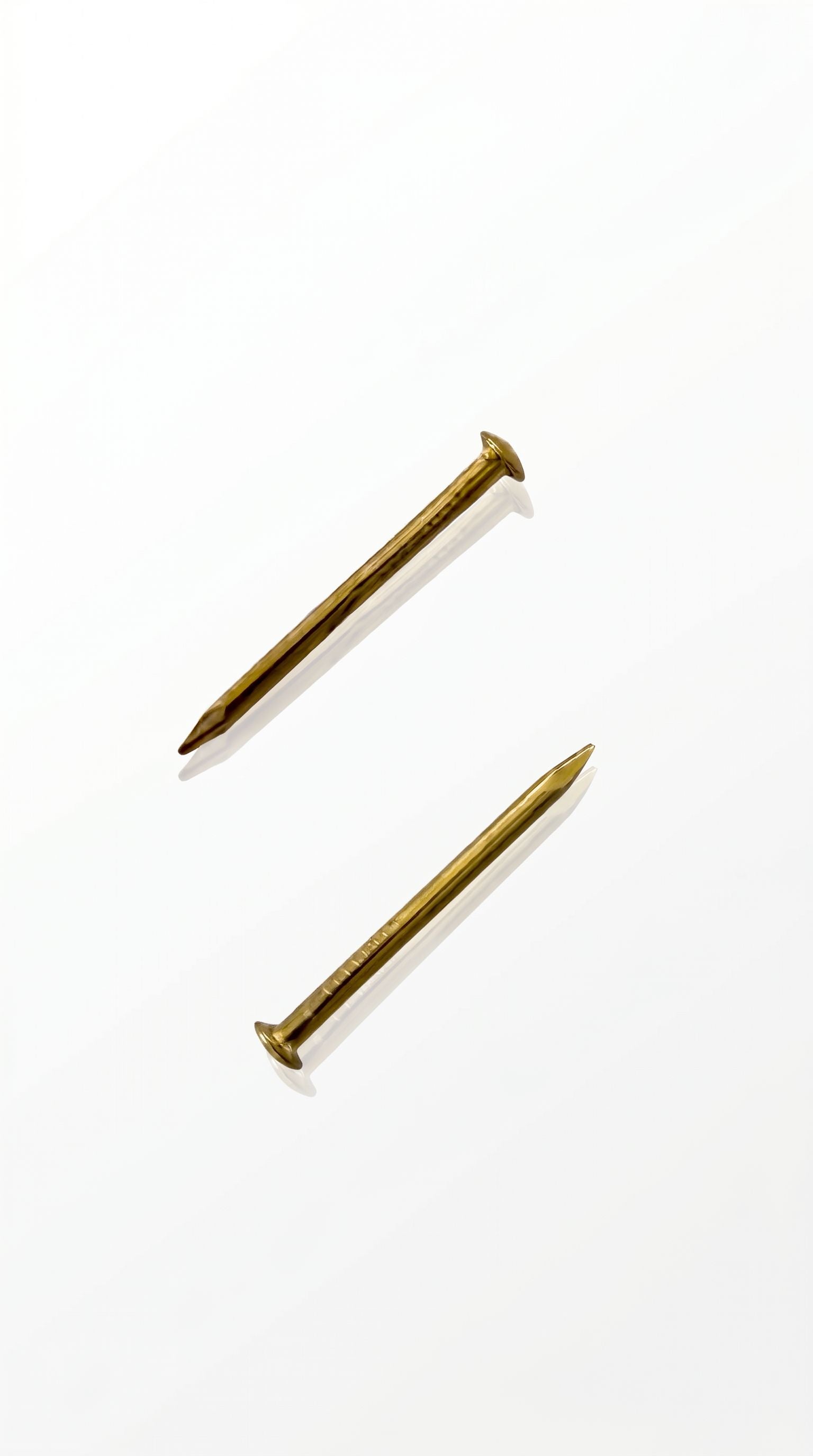 Gold mezuzah nails for mounting mezuzah cases to doorposts with a warm elegant hardware finish