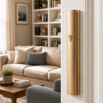 The Modern Waterproof Gold Aluminum Outdoor Mezuzah cover affixed to a doorpost