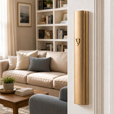 The Modern Waterproof Gold Aluminum Outdoor Mezuzah cover affixed to a doorpost