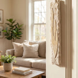 Sculpted Light Within Jerusalem stone mezuzah mounted on a cream interior doorway in a modern home
