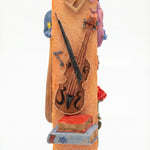 Decorative mezuzah case with musical instruments on an orange background