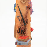 Decorative mezuzah case with musical instruments on an orange background
