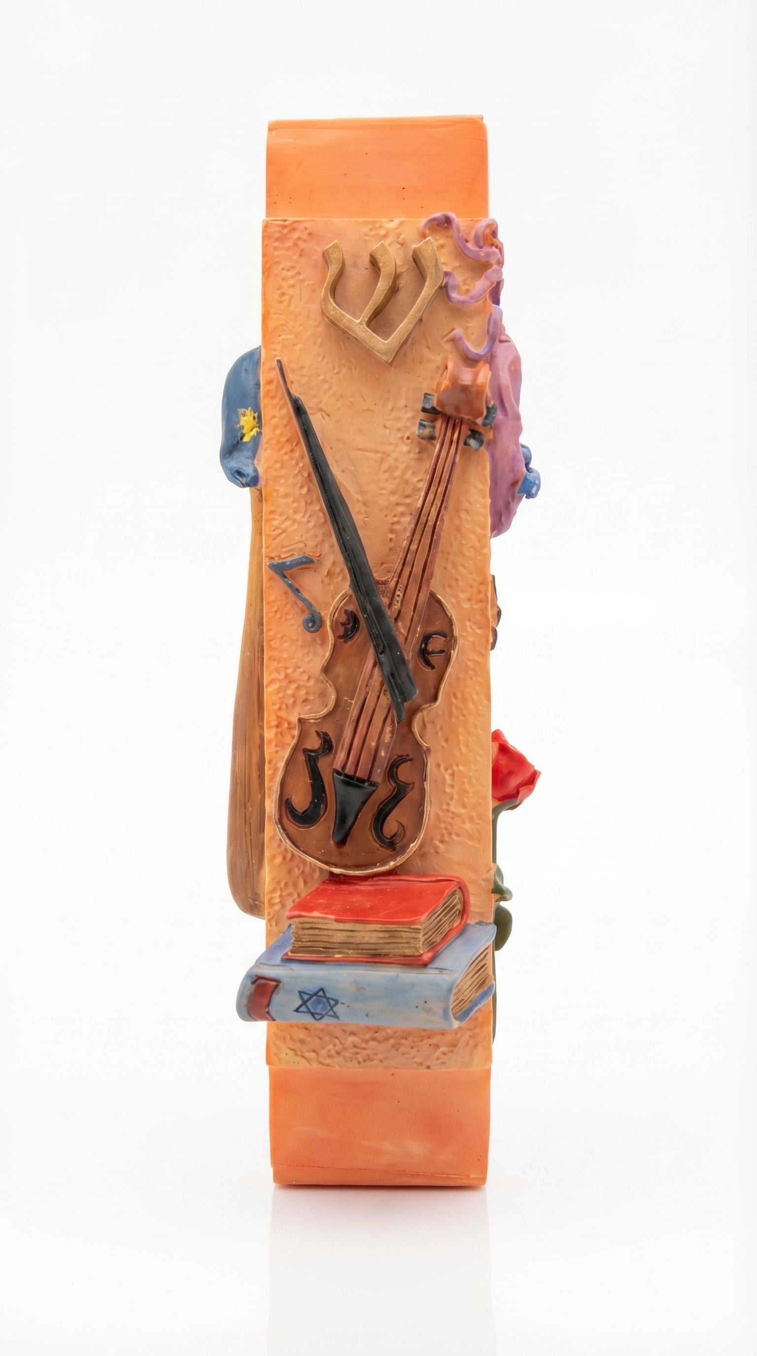 Decorative mezuzah case with musical instruments on an orange background