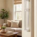 Timeless Clear Silver Shin Outdoor Mezuzah mounted vertically on a cream-colored doorway in a modern home