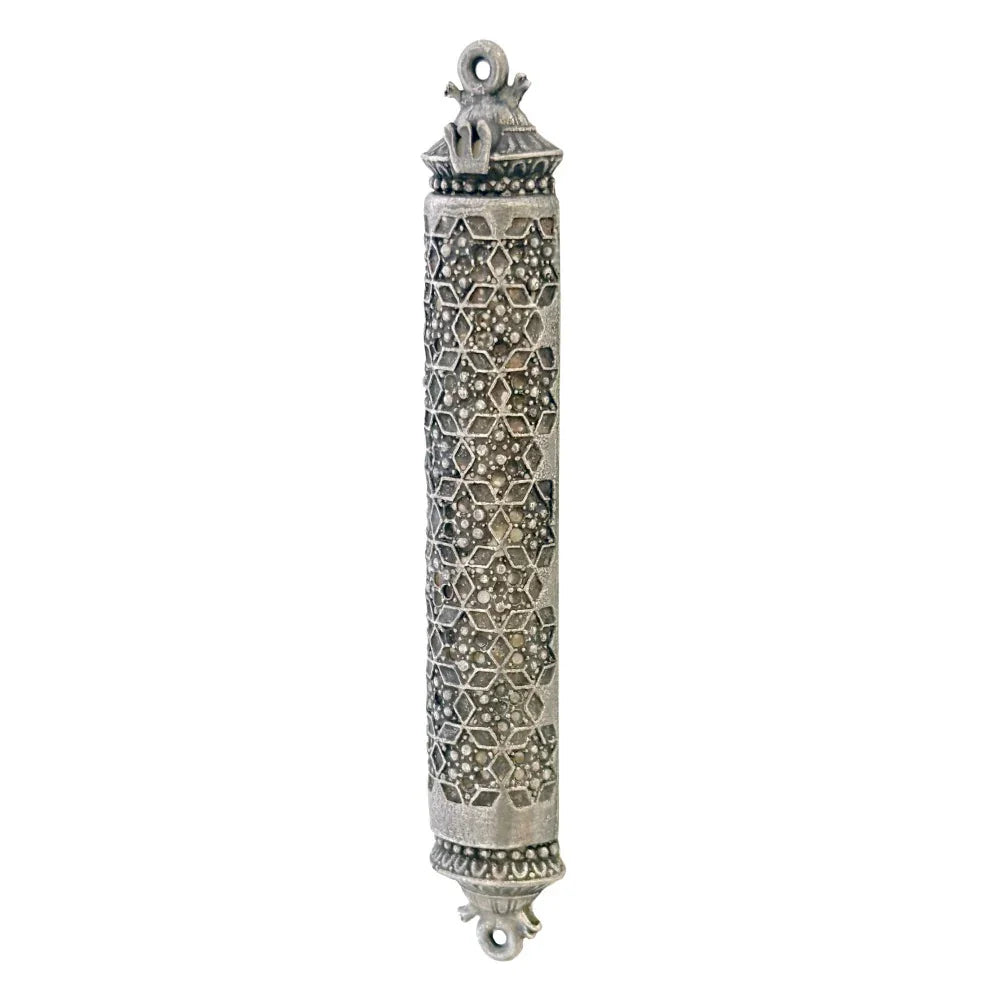 Decorative silver mezuzah case with geometric design on a white background