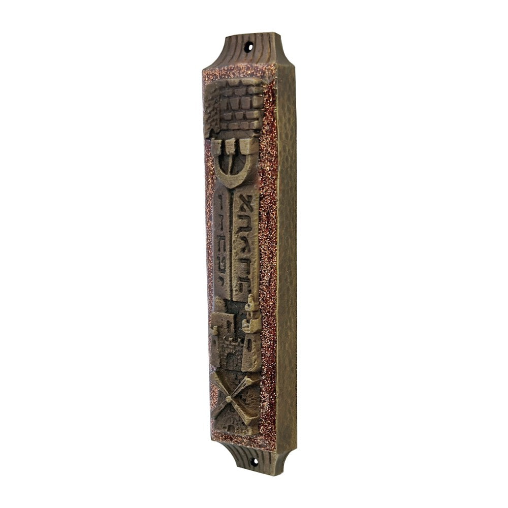 Decorative metal mezzuzah with Hebrew text on a white background