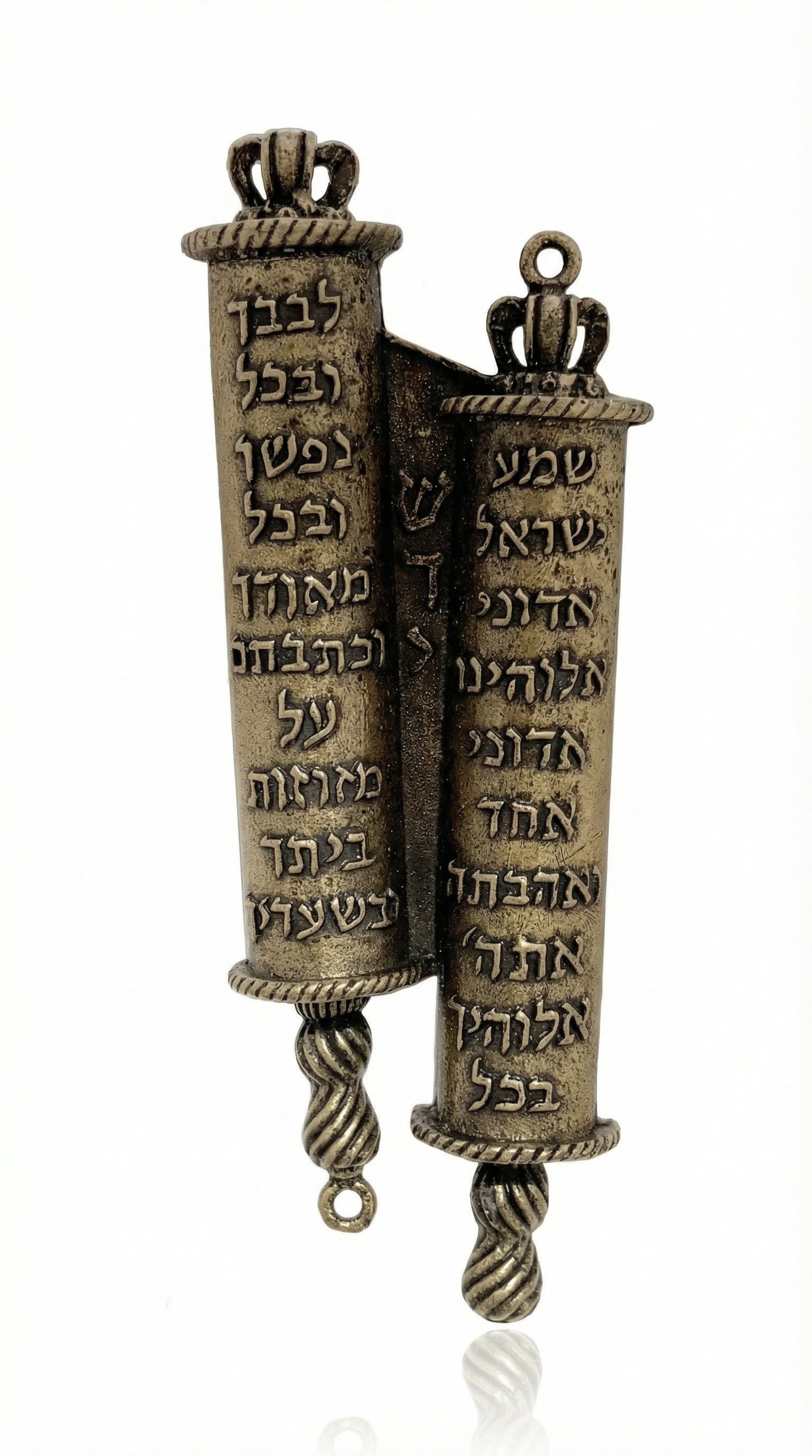 Crown-topped brass mezuzah case inspired by twin Torah scrolls, detailed Hebrew script, regal crown finials, on a white studio surface.