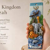 Hand-held animal kingdom mezuzah with colorful safari animals and Shalom banner, perfect for children's rooms and family spaces.