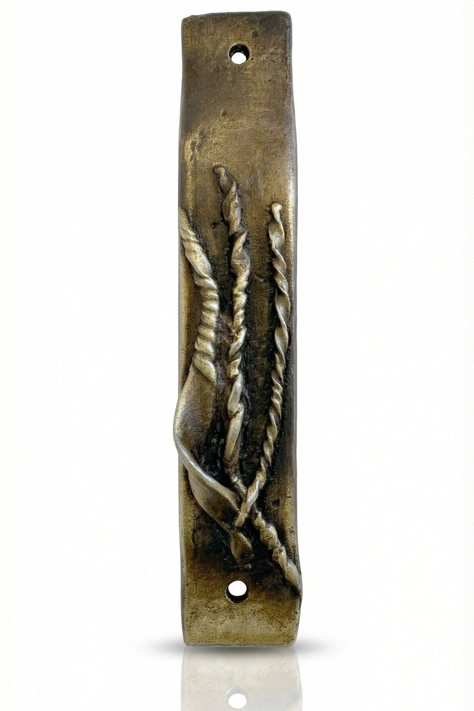 Antique brass Mezuzah measuring 4 inches in a bright, neutral white studio setting with soft reflection, showcasing fine details and craftsmanship.