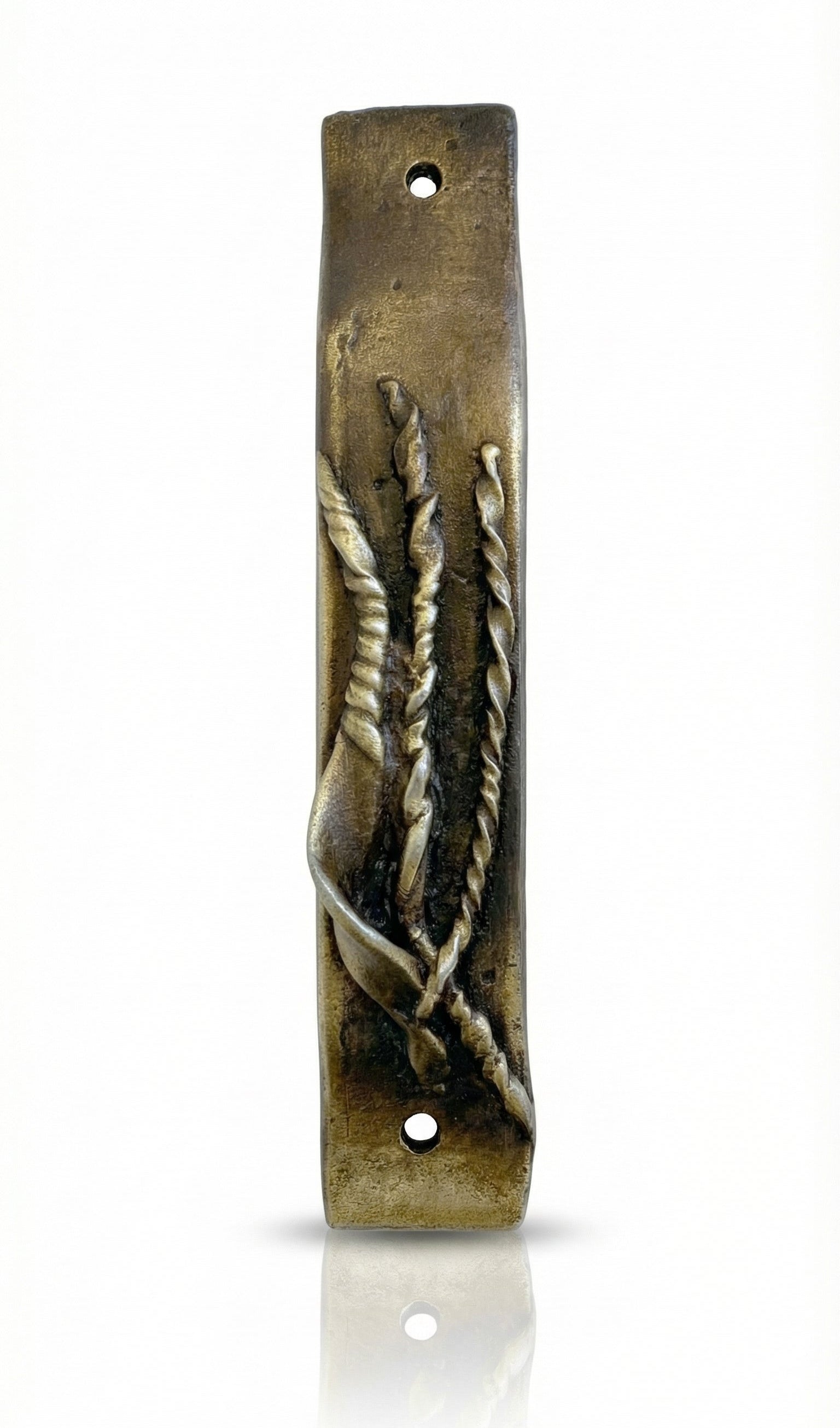 Antique brass Mezuzah measuring 4 inches in a bright, neutral white studio setting with soft reflection, showcasing fine details and craftsmanship.