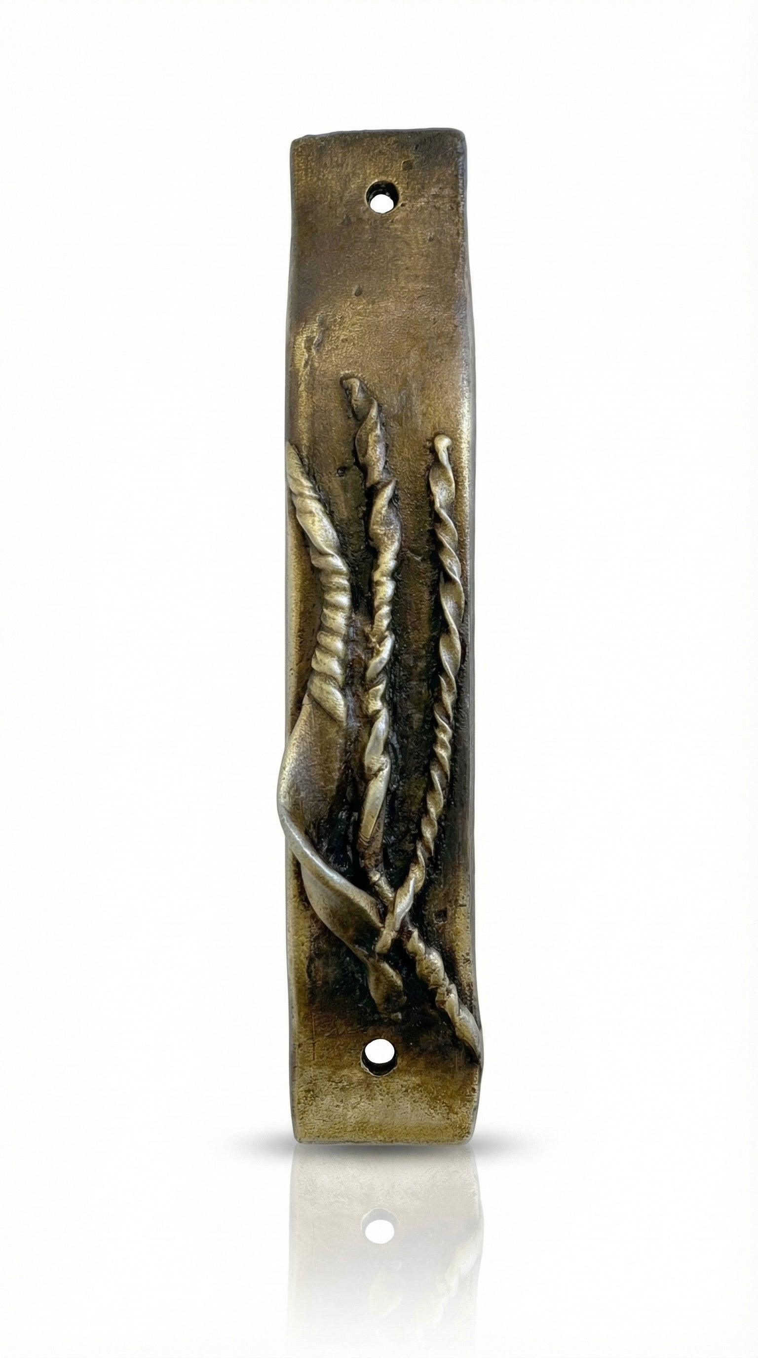 Antique brass Mezuzah measuring 4 inches in a bright, neutral white studio setting with soft reflection, showcasing fine details and craftsmanship.