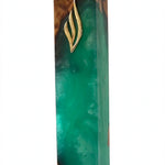 Angled studio view of the Artistic Olive Wood Emerald Green Resin Mezuzah, an olive wood mezuzah case from Israel with translucent emerald resin, rich brown wood grain and a gold Shin, holding a 6-inch kosher scroll