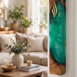 Emerald green resin and olive wood mezuzah mounted on a white doorframe in a bright living room, showing the glowing green resin, natural wood edges and gold Shin of this handcrafted Israeli mezuzah case at doorpost scale