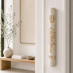 Etz Chaim cream stone mezuzah mounted on a living room doorway doorpost.