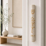 Etz Chaim cream stone mezuzah mounted on a living room doorway doorpost.