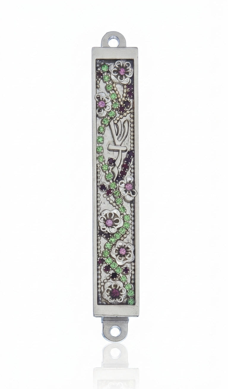 Petite floral Mezuzah with jewel-toned embellishments on a metal base, measuring 3.4 inches tall, displayed on a clean white studio surface with a soft reflection.