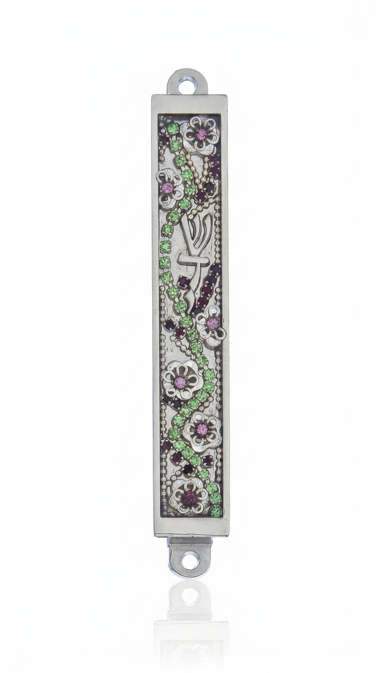 Petite floral Mezuzah with jewel-toned embellishments on a metal base, measuring 3.4 inches tall, displayed on a clean white studio surface with a soft reflection.