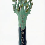 Detailed photo of an Avatar Mezuzah made of pewter, hand-painted with enamel, displayed on a clean white studio background with soft reflection.