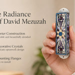 Azure Radiance Star of David Mezuzah mezuzah cover held upright in one hand, showing silver-toned openwork, purple accents and a gold-colored Magen David with a sparkling blue center and blue decorative border beside the product name and illustrated design features in a wide social-sharing graphic for decorative Jewish home Judaica