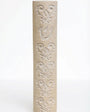 Cylindrical cream Jerusalem stone mezuzah case with carved baroque floral patterns and a Shin.