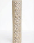 Cylindrical cream Jerusalem stone mezuzah case with carved baroque floral patterns and a Shin.