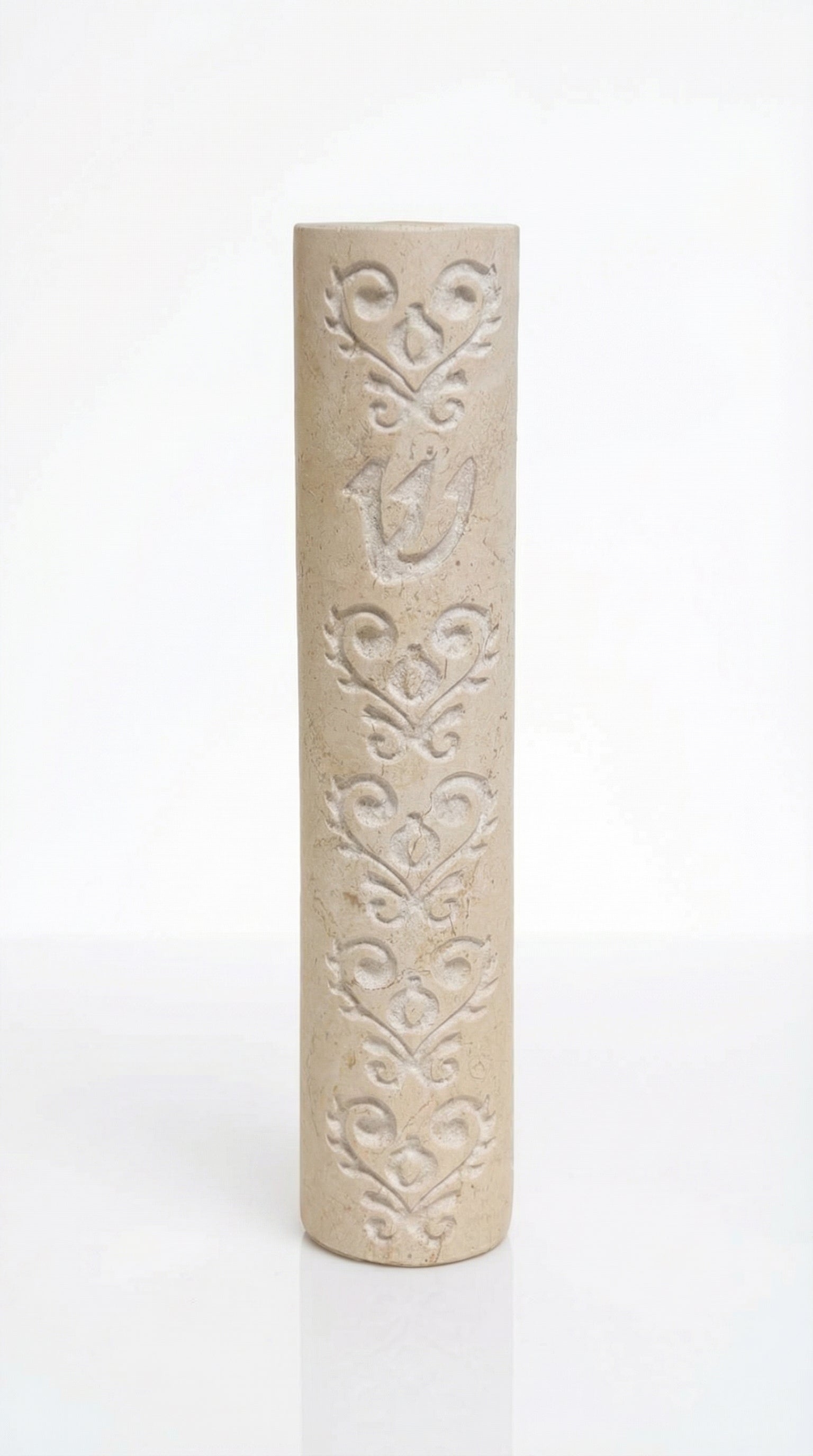 Cylindrical cream Jerusalem stone mezuzah case with carved baroque floral patterns and a Shin.