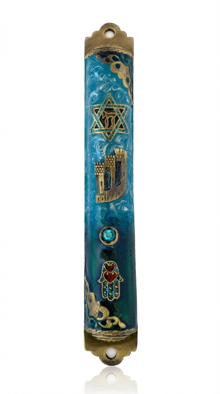 Elevated photo of a brass Beach Mezuzah with detailed Hebrew engravings, displayed on a clean white background with a subtle reflection.