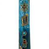 Elevated photo of a brass Beach Mezuzah with detailed Hebrew engravings, displayed on a clean white background with a subtle reflection.