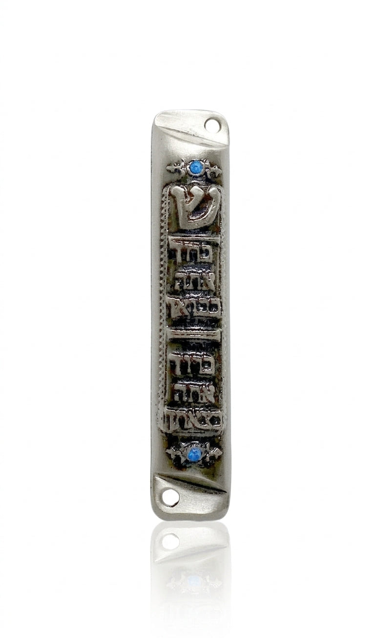 Elegant Pewter Birchat Habayit Mezuzah with blue accents and Hebrew blessing for home, displayed on a white background with soft reflection.