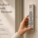 Handheld Birkat HaBayit white cement mezuzah case with raised gold Shin and full Hebrew blessing for the home, shown beside product information to highlight the slim profile, gold accent, decorative Jewish text, and Israeli Judaica design