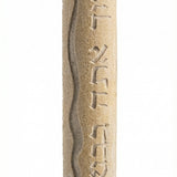 Handmade mezuzah from Jerusalem stone, engraved Hebrew blessing for home, with detailed relief and decorative motifs on a white background.