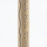 High-resolution image of handcrafted Mezuzah made of Jerusalem stone, engraved Hebrew blessing, on a white studio background with soft reflection.