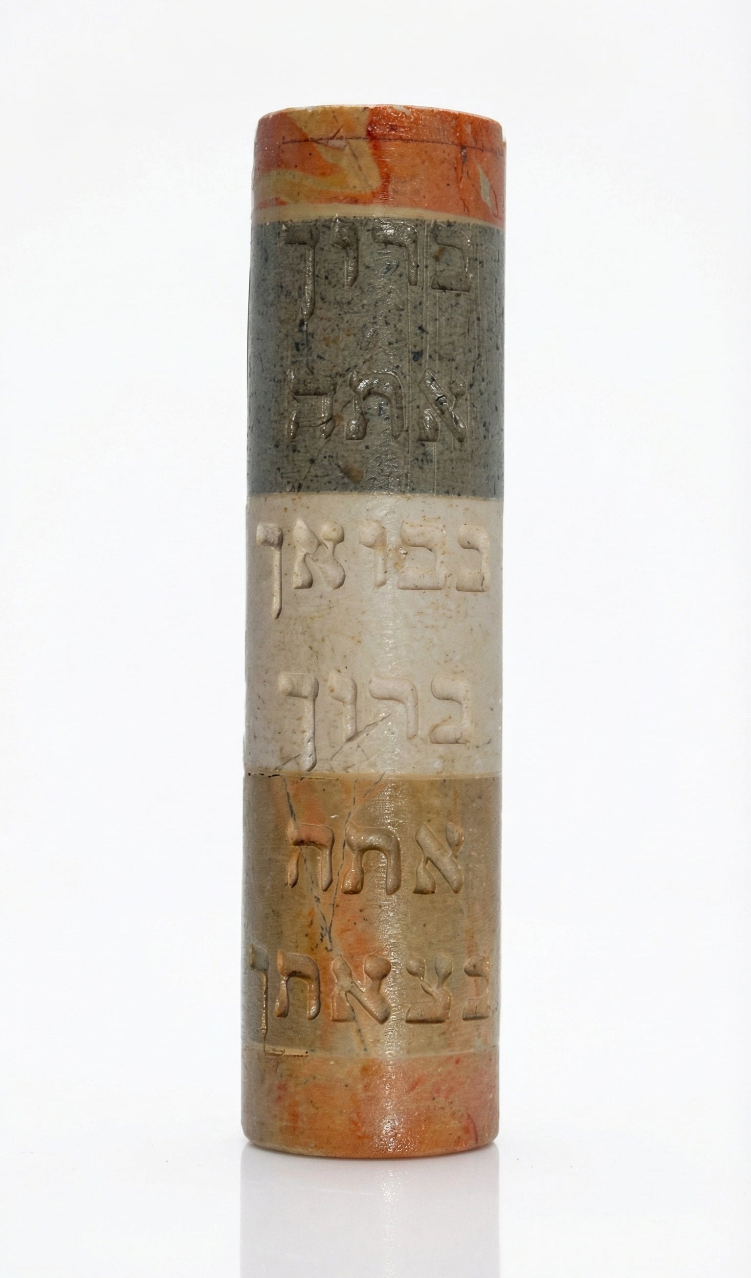 Handmade Israeli stone Mezuzah with Hebrew blessing, engraved with Jerusalem and Hebron scenery, on a white studio background with soft reflection.