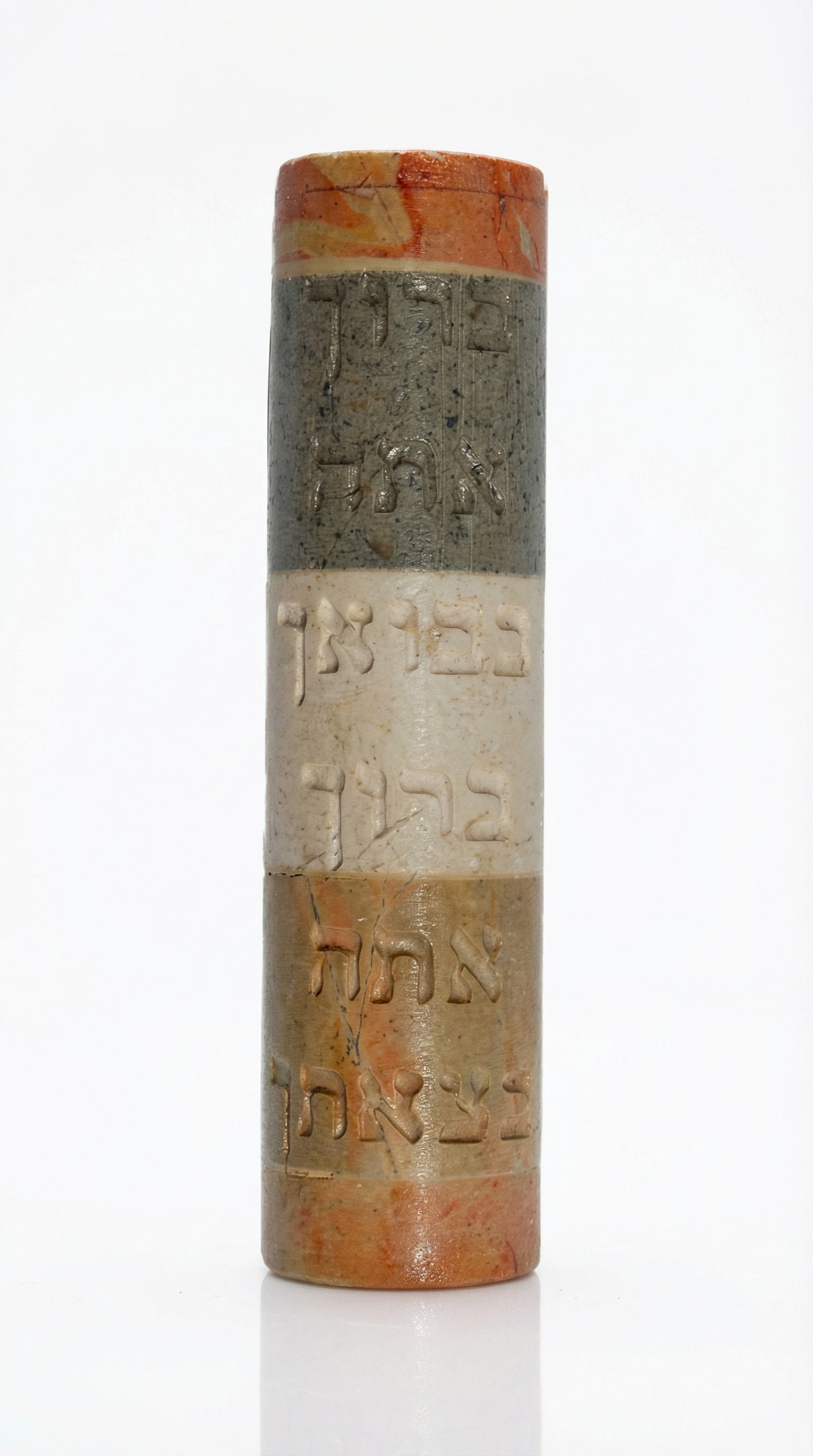 Handmade Israeli stone Mezuzah with Hebrew blessing, engraved with Jerusalem and Hebron scenery, on a white studio background with soft reflection.