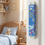 Dove of Peace ceramic mezuzah mounted on doorway, blue and red design, suitable for indoor and protected outdoor use.