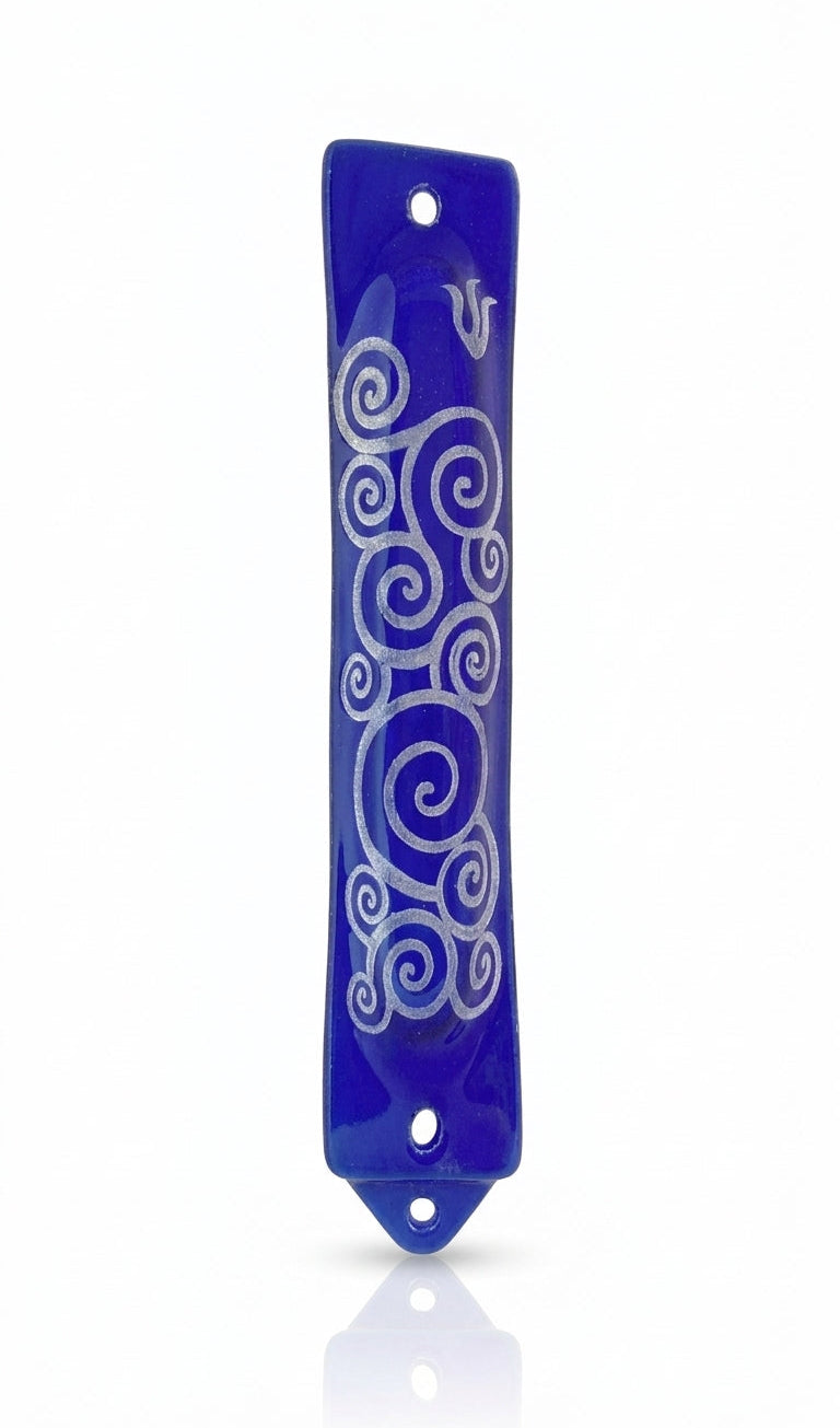 Elegant blue glass mezuzah with detailed Hebrew engravings, mounted with screws or tape, on a white studio background with soft reflection.
