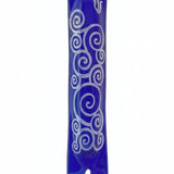 Elegant blue glass mezuzah with detailed Hebrew engravings, mounted with screws or tape, on a white studio background with soft reflection.