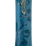 Blue glass mezuzah with detailed Hebrew inscriptions, engraved motifs, and textured surface, displayed on a clean white background with subtle reflection.