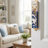 Twelve Jewels Dove Blue Mezuzah mounted on door frame with indoor room in background.