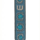 Upscale image of a 4-inch tall Blue Sky Mezuzah with detailed engraving and Hebrew letters on a bright white background with soft reflection.