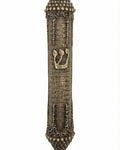 Elegant brass mezuzah with antique finish, 5.5 inches tall, featuring detailed Hebrew engravings and decorative motifs on a white studio background.