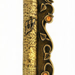 Elegant brass mezuzah with detailed pomegranate motifs and shiny accent stones, crafted in Israel, measuring 5.25 inches tall.