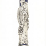 High-quality image of a hand-painted pewter Mezuzah depicting a bride and groom, with detailed craftsmanship and a white studio background.