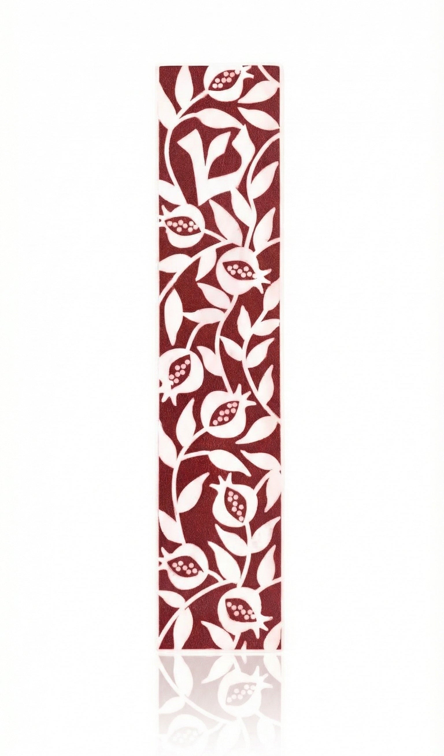 Elegant burgundy pomegranate mezuzah made of acrylic with detailed Hebrew engravings, set against a bright white background with a subtle reflection.